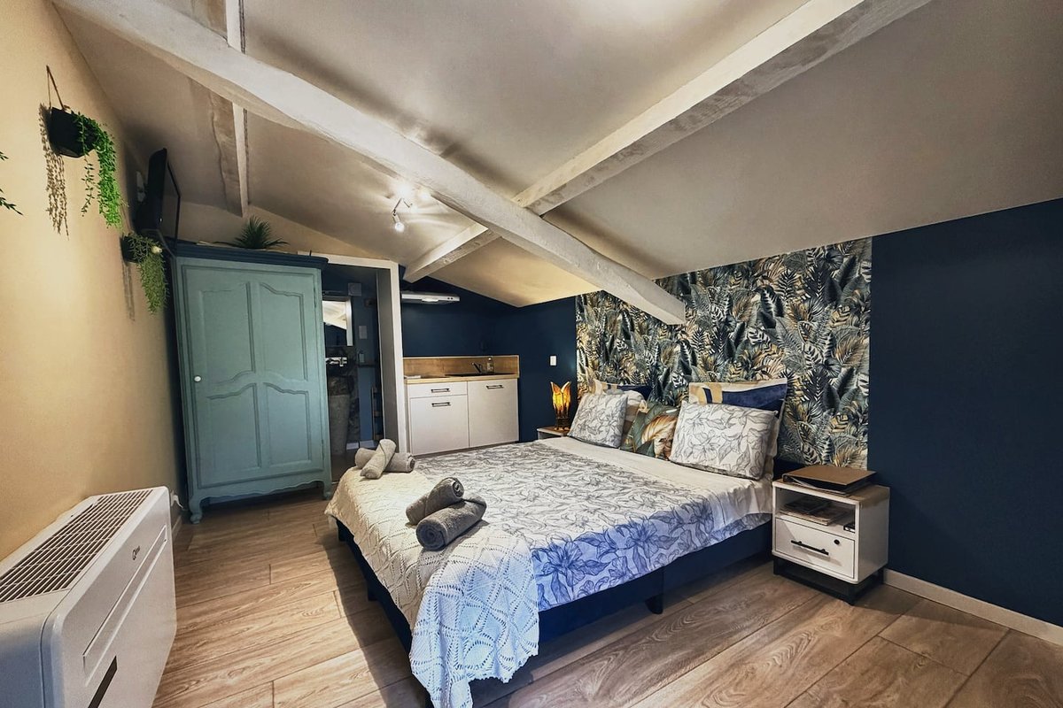 Lou Pitchoun's sleeping area with wardrobe and double bed