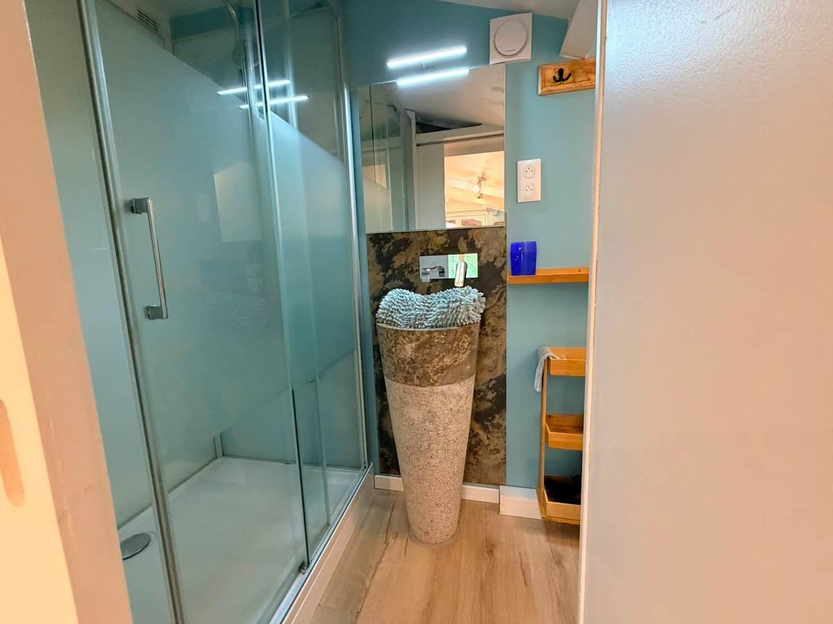 Lou Pitchoun's modern shower room, glass shower and stone basin